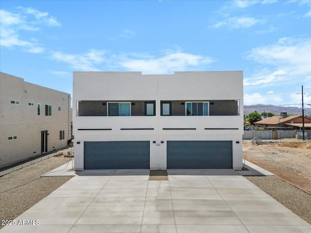 2559 E Broadway Rd, Phoenix, AZ 85040 - view of front of house with an attached garage, concrete driveway, and stucco siding