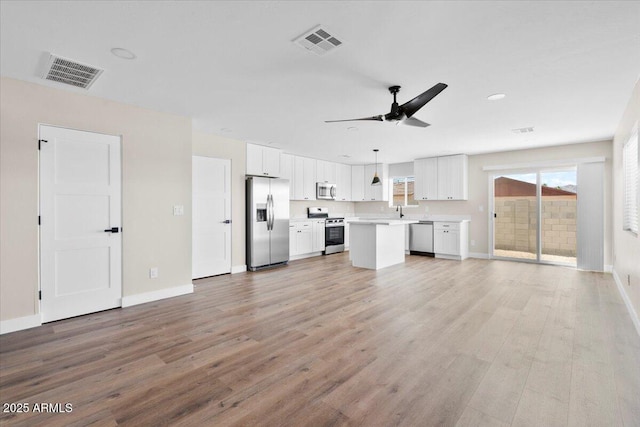 2559 E Broadway Rd, Phoenix, AZ 85040 - unfurnished living room featuring light wood finished floors and a ceiling fan