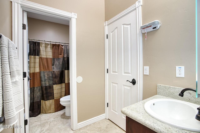 bathroom with vanity, tile patterned floors, and toilet