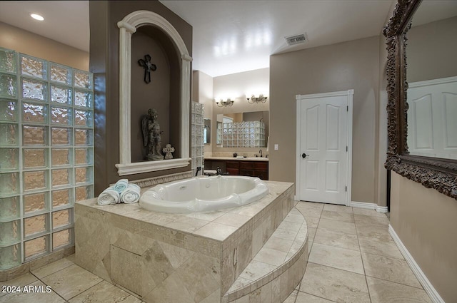 bathroom with vanity and a relaxing tiled tub