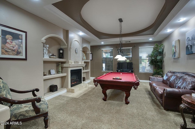 recreation room with built in shelves, light colored carpet, a tray ceiling, and pool table