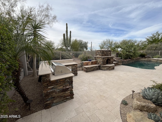 view of patio / terrace with an outdoor kitchen, an outdoor stone fireplace, a fenced in pool, and fence