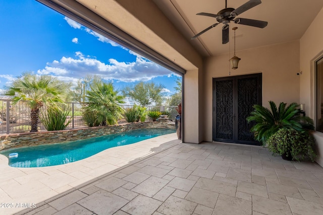 view of swimming pool featuring a ceiling fan, a patio area, a fenced in pool, and a fenced backyard
