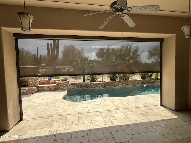 view of pool featuring a ceiling fan, a patio, glass enclosure, and a fenced in pool