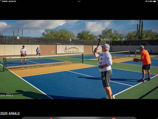 view of sport court featuring community basketball court and fence