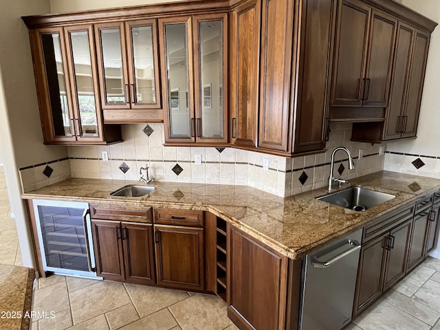 kitchen featuring a sink, decorative backsplash, and wine cooler