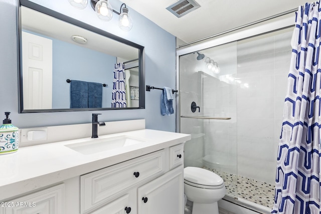 bathroom with vanity, toilet, and an enclosed shower