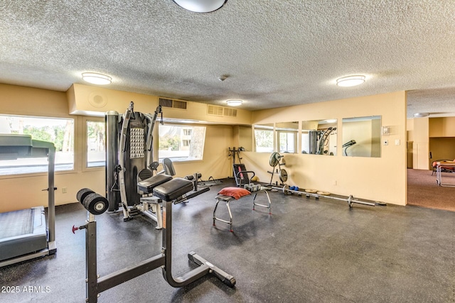 workout room featuring a textured ceiling