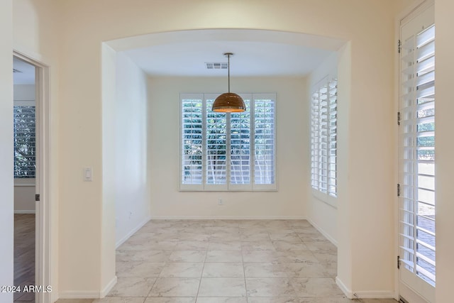 unfurnished dining area with a healthy amount of sunlight