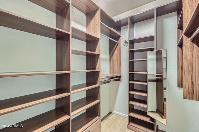 spacious closet featuring light hardwood / wood-style floors