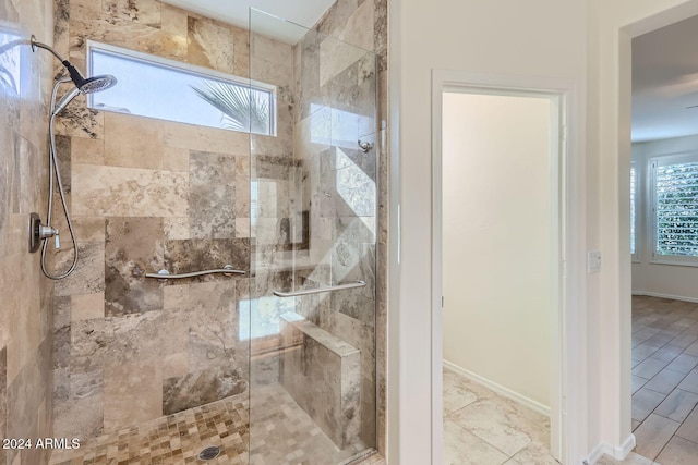 bathroom with a shower with door