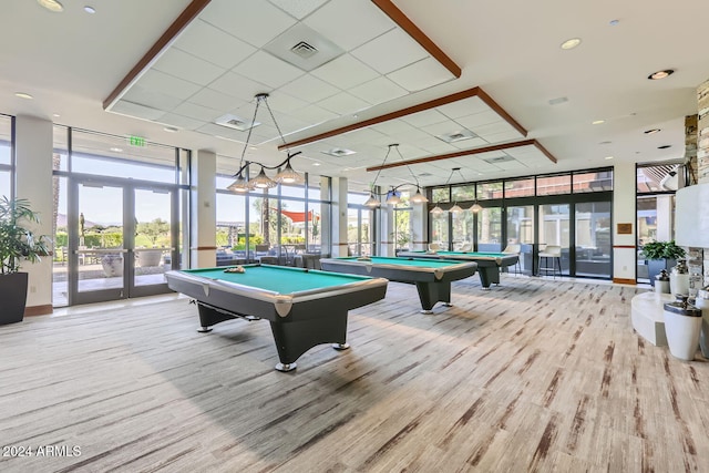 recreation room featuring light hardwood / wood-style floors, expansive windows, and billiards