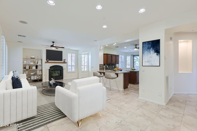 living room featuring sink and ceiling fan