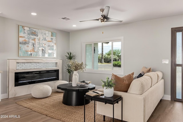 living room featuring ceiling fan and wood-type flooring