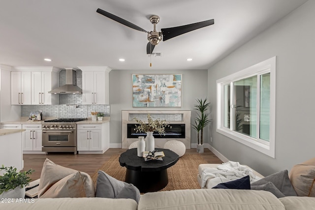 living room featuring dark hardwood / wood-style floors and ceiling fan