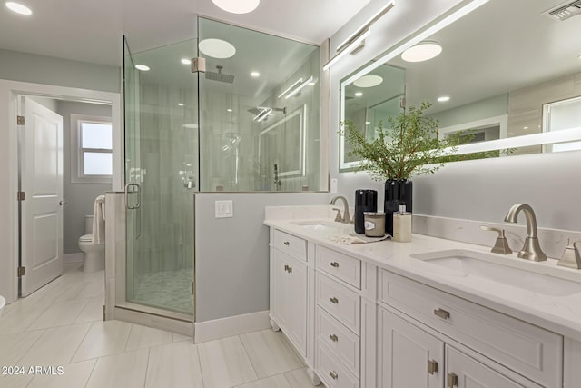 bathroom with tile patterned flooring, vanity, toilet, and an enclosed shower