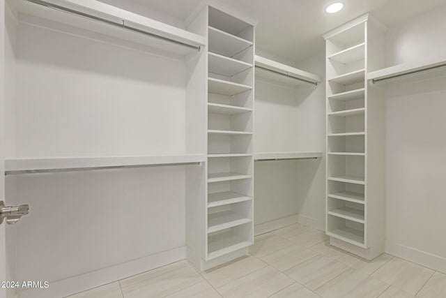 walk in closet with tile patterned floors