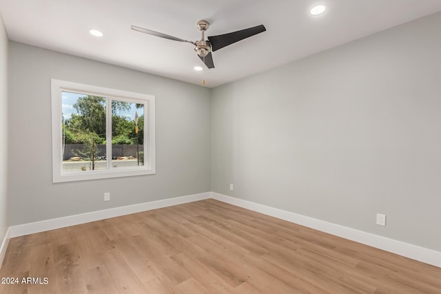 empty room featuring ceiling fan and light hardwood / wood-style flooring