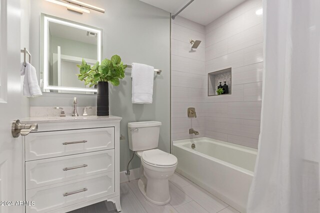 full bathroom featuring toilet, vanity, shower / tub combo with curtain, and tile patterned flooring