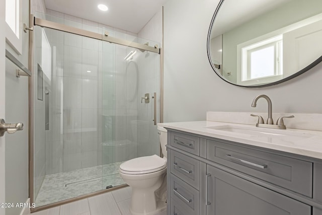 bathroom with walk in shower, tile patterned flooring, vanity, and toilet