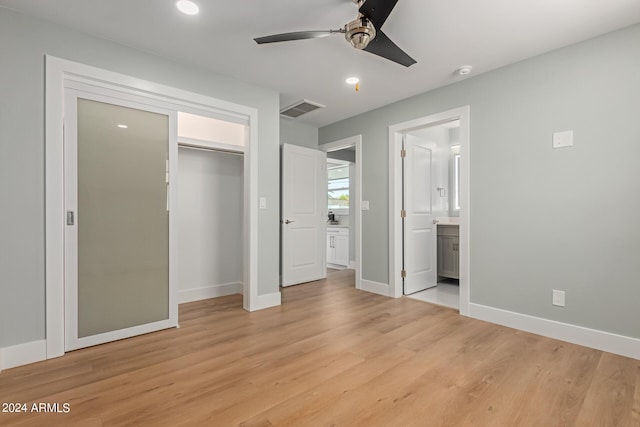 unfurnished bedroom with light wood-type flooring, connected bathroom, a closet, and ceiling fan