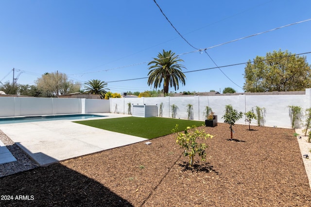 view of yard with a fenced in pool and a patio