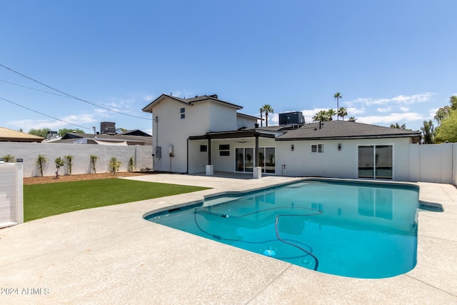 view of swimming pool featuring a lawn, central AC unit, and a patio area