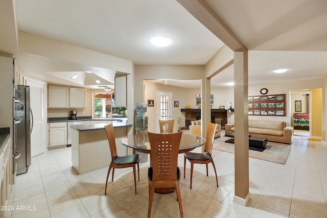 dining area with a textured ceiling and light tile patterned floors