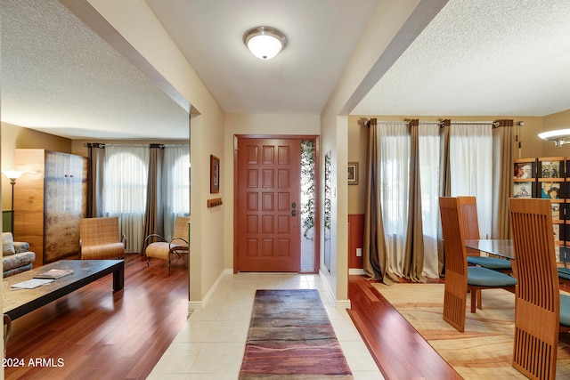 foyer featuring a textured ceiling and light wood-type flooring