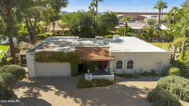 mediterranean / spanish-style house with a garage