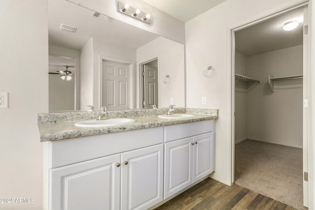 bathroom with vanity, hardwood / wood-style flooring, and ceiling fan