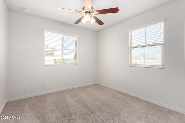 spare room with light carpet and ceiling fan