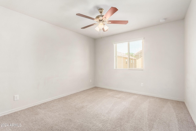 spare room featuring ceiling fan and carpet floors