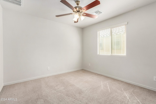 carpeted empty room featuring ceiling fan