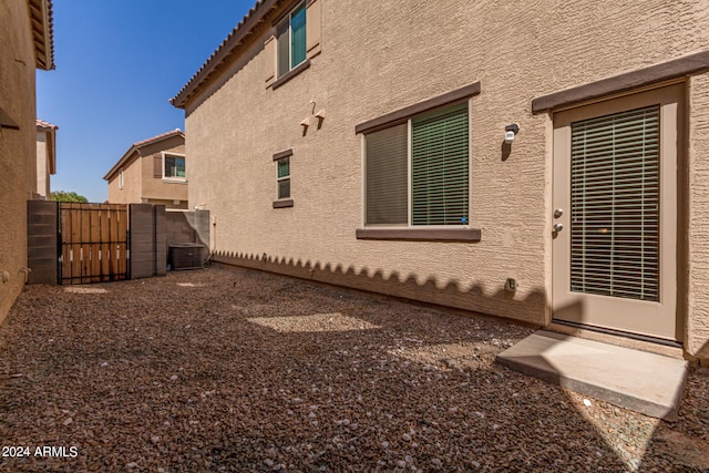 view of side of home with central AC