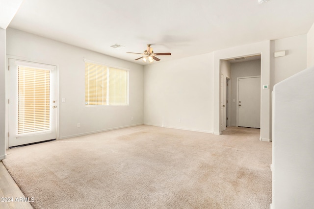 carpeted spare room with ceiling fan