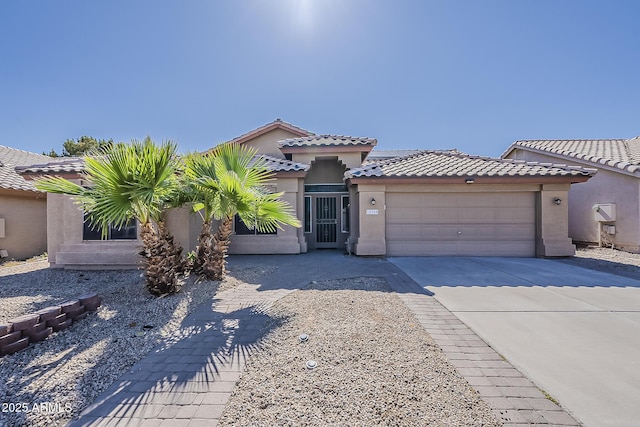 15360 N 87th Ave, Peoria, AZ 85381 - view of front of house with a garage, driveway, stucco siding, and a tiled roof