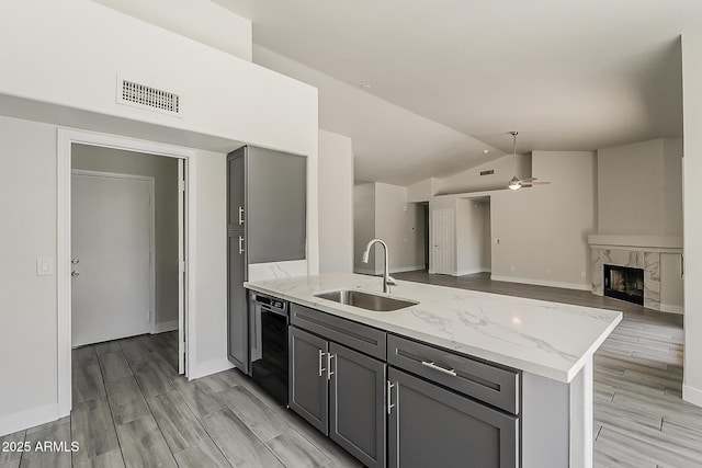 15360 N 87th Ave, Peoria, AZ 85381 - kitchen featuring a sink, gray cabinets, a peninsula, black dishwasher, and lofted ceiling