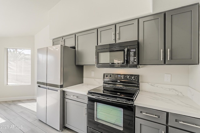 15360 N 87th Ave, Peoria, AZ 85381 - kitchen featuring black appliances, gray cabinets, baseboards, and light stone countertops