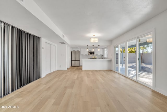 unfurnished living room featuring light hardwood / wood-style floors