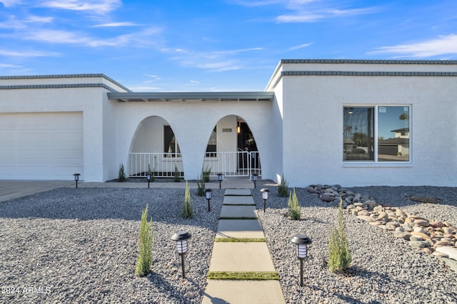 view of front of house with a porch and a garage