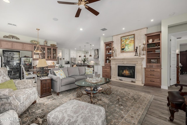 living room featuring hardwood / wood-style flooring and ceiling fan