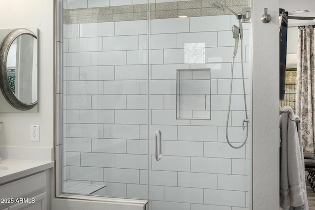 bathroom featuring an enclosed shower and vanity