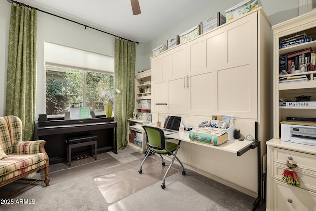 carpeted office featuring ceiling fan