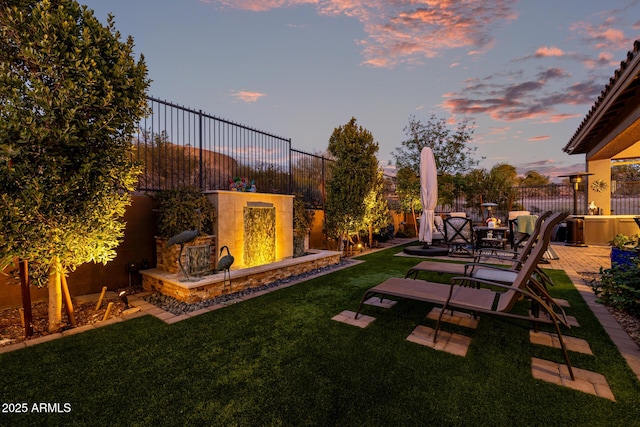 yard at dusk with a patio