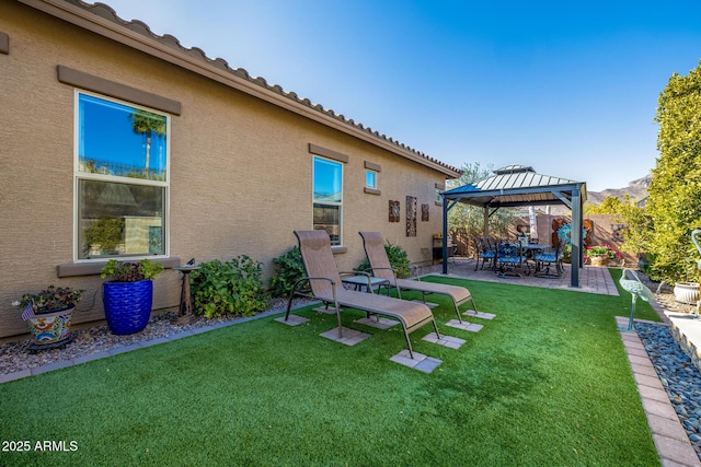 view of yard with a gazebo, a mountain view, and a patio