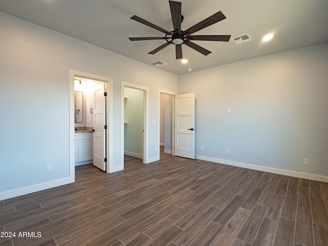 unfurnished bedroom with ensuite bath, ceiling fan, and dark hardwood / wood-style floors