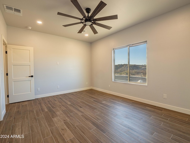 empty room with ceiling fan and dark hardwood / wood-style floors