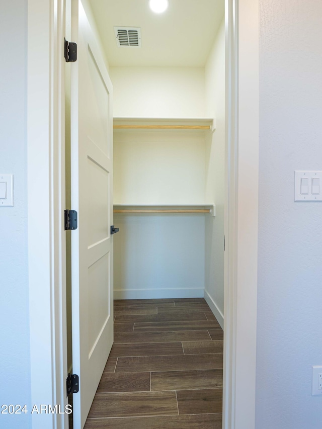 spacious closet with dark hardwood / wood-style floors