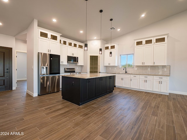 kitchen featuring pendant lighting, a center island, appliances with stainless steel finishes, dark hardwood / wood-style flooring, and white cabinetry